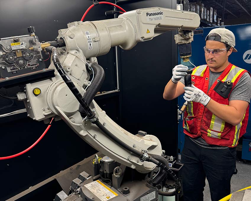 Photo showing an Altech technician doing a robotic arm repair
